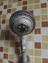 Old and dirty shower head in bathroom