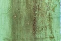 Dirty texture of plaster and green paint, shabby aged surface, remnants of peeling cracked stucco, grunge uneven wall Royalty Free Stock Photo