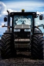 Old, dirty tractor against a blue sky Royalty Free Stock Photo