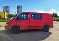 Old dirty red van Ford Transit parked