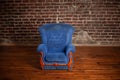 Old dirty vintage blue armchair standing indoor