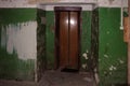 Old dirty walls and entry doors of elevator in an abandoned house Royalty Free Stock Photo