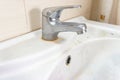 Old dirty washbasin with rust stains, limescale and soap stains in the bathroom with a faucet, water tap Royalty Free Stock Photo