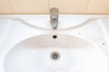 Old dirty washbasin with rust stains, limescale and soap stains in the bathroom with a faucet, water tap Royalty Free Stock Photo