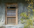 Old dirty window framework with jail bars in a stone wall Royalty Free Stock Photo