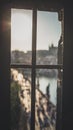 Old dirty window with spider web on Old Town Bridge Tower with blurred Charles Bridge in background. Prague, Czech Republic