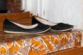 Old dirty women`s flat shoes stand on the doorstep of the house Royalty Free Stock Photo