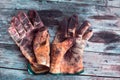 Working gloves over wooden table, gloves for each finger