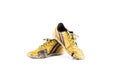 Old dirty yellow  football shoes damaged on white background football  object isolated Royalty Free Stock Photo