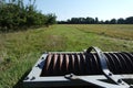 Old disc harrow at the side of a field come orchard