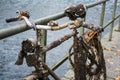 Old discarded bicycle leaning against a railing at the water, full of rust, small clams and barnacles, found in the canal, detail