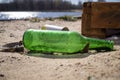Old discarded empty green bottle and tin can