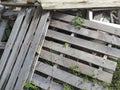 Old discarded wooden pallets abandoned. Stack of wooden boards background. Pile of grunge wood pallets placed randomly, dumped in Royalty Free Stock Photo