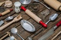 Old dishes and cutlery on a wooden background in red, silver and