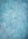 Old distressed faded blue grunge background with lots of abstract grungy texture and grain from old barn wood and crinkled paper