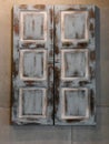 Old Distressed Window Shutters With White Paint On Brown Wood