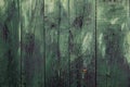 Old distressed wooden planks wall with worn out green peeling paint Royalty Free Stock Photo