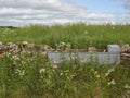 An old disused Galvanised metal Cattle Water Trough situated in a Dry stone wall in a Field in Angus.