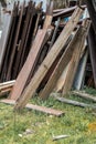 Old, disused wooden slats piled up outside the house. Useless stuff. Royalty Free Stock Photo