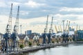 Old Dockside Cranes alongside a Waterfront Development  in London Royalty Free Stock Photo