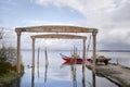 Old dockyard on the lagoon with red boat at entrance Royalty Free Stock Photo