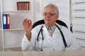 Old doctor with glasses observe red pill Royalty Free Stock Photo