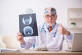 Old male doctor otologist working in the clinic