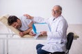 Old male doctor psychiatrist examining young male patient