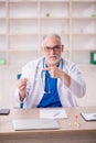 Old male doctor wearing mask in the clinic Royalty Free Stock Photo