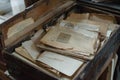 Old documents and letters resting in a dusty wooden box Royalty Free Stock Photo