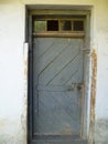 Old door from barn with broken window Royalty Free Stock Photo