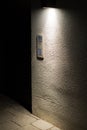 Old door bell with intercom illuminated at night Royalty Free Stock Photo