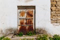 Old door boarded up with a wooden log. Derelict building with boarded doors Royalty Free Stock Photo