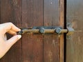 Old door bolt on wooden door. Selective focus.