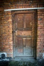 old door of brick building close up. The red brick wall and wooden door shot Royalty Free Stock Photo