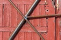 Old door is closed by a metal beam Royalty Free Stock Photo