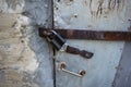 Old door closed on padlock. Bolt, door handle. Royalty Free Stock Photo