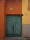 Old door between colored walls Royalty Free Stock Photo
