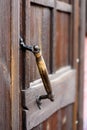 Old door handle on a wooden door Royalty Free Stock Photo