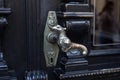 Old door handle. Wooden vintage entrance door with antique door handles in the shape of bird. Selective focus Royalty Free Stock Photo
