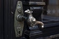 Old door handle. Wooden vintage entrance door with antique door handles in the shape of bird. Selective focus Royalty Free Stock Photo