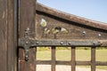 Old door hinge attached to a wooden gate Royalty Free Stock Photo