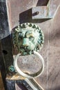 Old door knocker, bronze lion, old door at the entrance of Toplou monastery, Crete, Greece Royalty Free Stock Photo