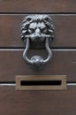 Old door knocker lion and mailbox