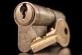 A old door lock on a dark background. A patent and keys to secure the front door Royalty Free Stock Photo