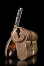 A old door lock on a dark background. A patent and keys to secure the front door Royalty Free Stock Photo