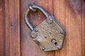Old door lock. Old locked padlock with rings on old wooden board door Royalty Free Stock Photo