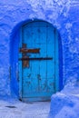 Old door of a house on a street painted blue in the medina of Chefchaouen, Morocco Royalty Free Stock Photo