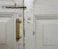 Old door, pen, vintage, paint, white, wallpaper, bolt, copper handle, valve, house, room, wooden Royalty Free Stock Photo