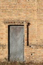 Old door studded with metal in an brick building